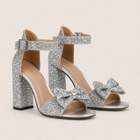 Mules à talons hauts avec nœud en gros plan, chaussure habillée et féminine.